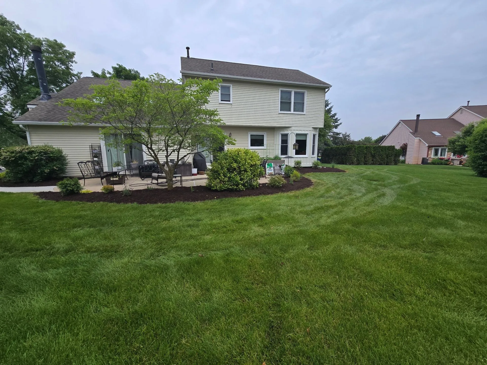 Landscaped property with a manicured lawn and mature plantings