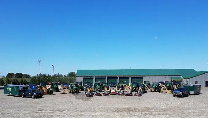 KBK Landscaping equipment lined up in front of the company facility